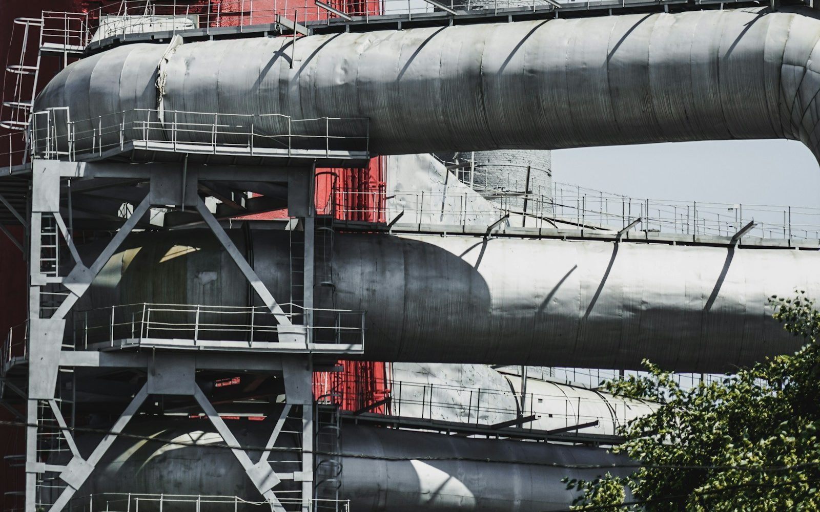 gray and red metal industrial pipework