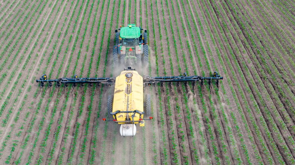 a tractor spraying chemical in the field