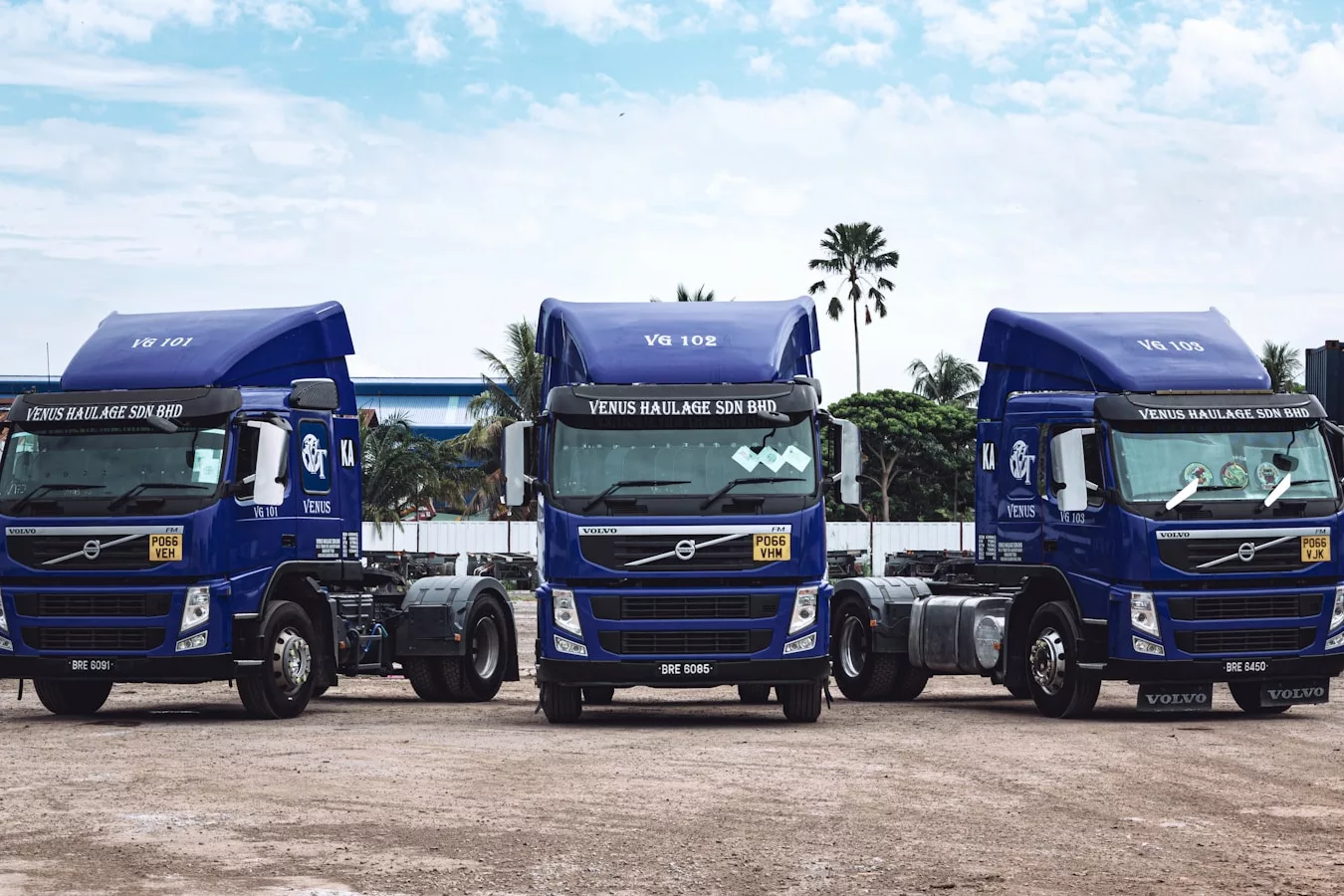 a couple of blue trucks parked next to each other